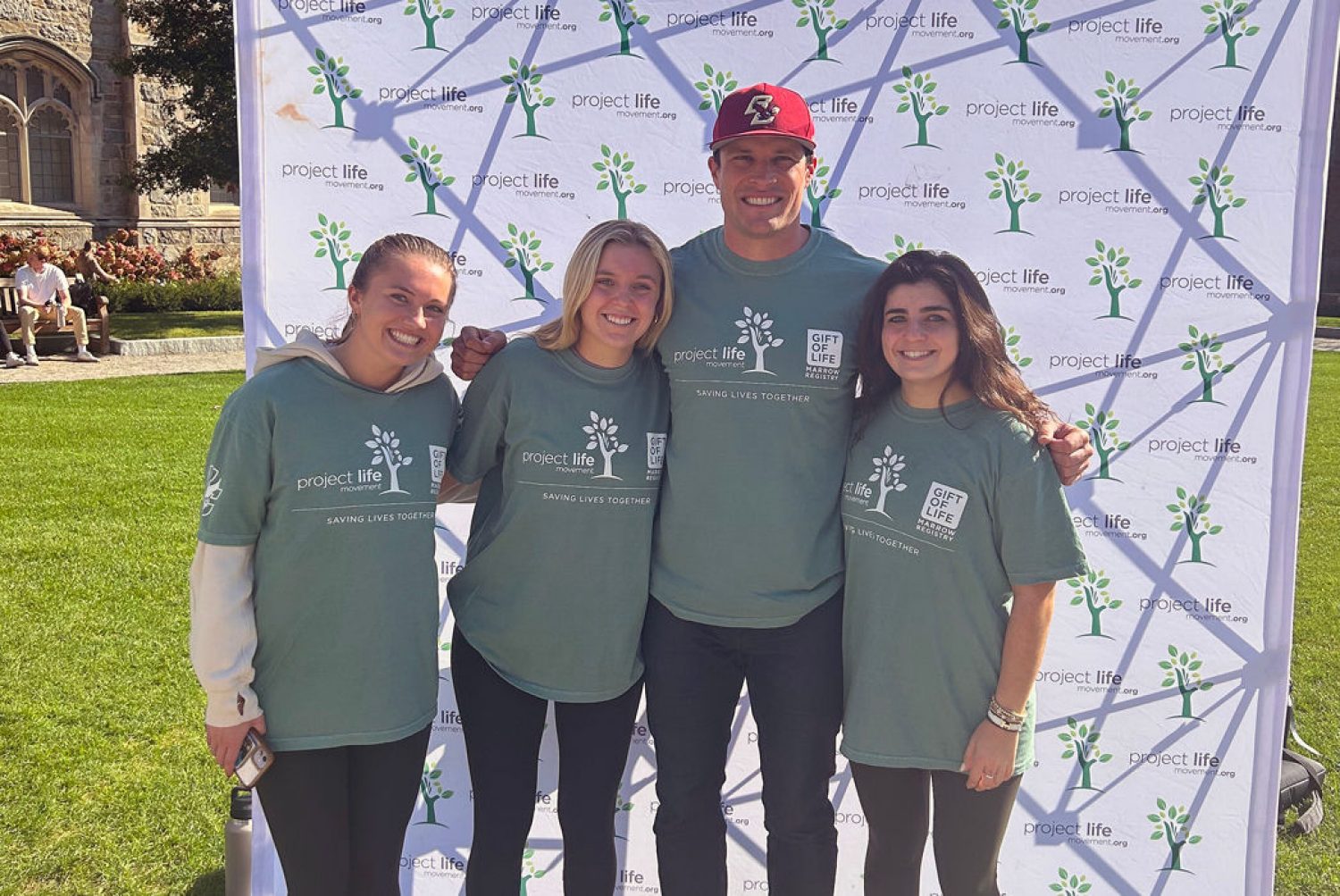 Luke Kuechly and three students in Project Life tees